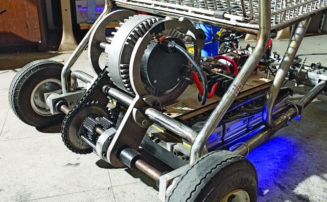The wheels and motor of a shopping cart go-kart.