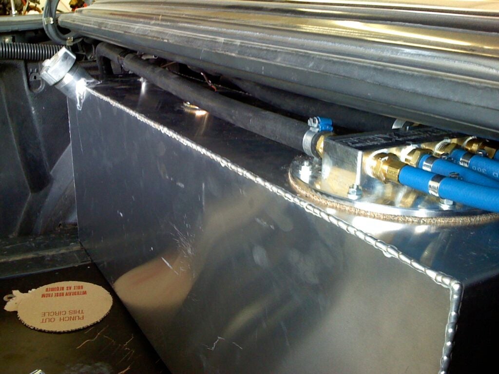 A fuel tank for vegetable oil-based fuel in the trunk of a Mercedes.