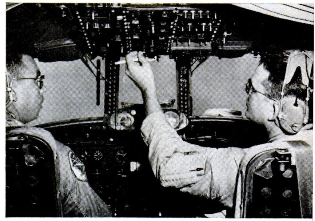 Second Pilot Des Phelan and copilot D. E. Edgren check the controls before setting out on another hurricane hunt.