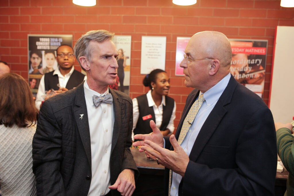 photo of Bill Nye talking with Robert Fraley