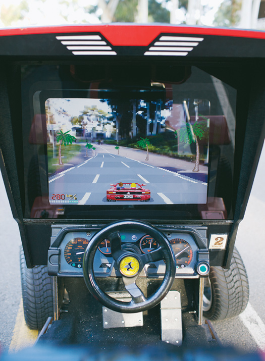Custom software renders the road ahead in 8-bit augmented-reality graphics. Anything else in front of the cameras appears onscreen as well.