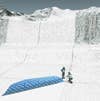 Easy Does it: Six people can roll out 15 of these 330-foot glacier blankets in two weeks.