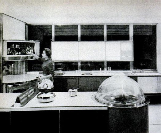 Frigidaire and General Motors' 1956 Kitchen of Tomorrow is the most iconic of its models, having been immortalized in a 10-minute musical film titled "Design For Dreaming." In this kitchen, an IBM-manufactured card containing a recipe file would not only display the picture of your dish on a screen, but it would dispense the ingredients and start preparing the dish for you. The clear domed oven, which you can see atop the counter pictured left, could roast a turkey within 45 minutes. If you stuck a bowl of batter in there, a birthday cake would emerge -- frosting, candles, and all. In the back corner, a rotating storage system would hold dry, refrigerated, and frozen goods. Electronically-controlled cabinets would use electric motors to rise and lower themselves. If all those appliances weren't enough, a laundry machine would automatically start washing clothes when the load reached 8 lbs. Read the full story in "A Kitchen to Dream About and Maybe Get--Tomorrow"