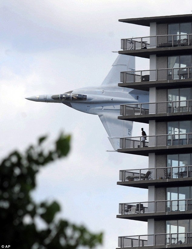 An F/A-18 Hornet buzzes an apartment building on the banks of the Detroit River
