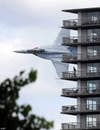 An F/A-18 Hornet buzzes an apartment building on the banks of the Detroit River