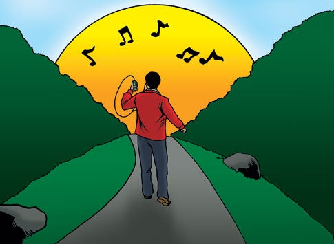 A man in a red jacket and jeans walking happily into the sunset along a path between large hedges while listening to music on an MP3 player.