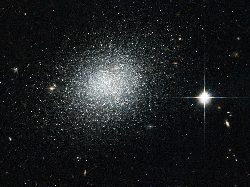 Captured by Hubble, this here is the dwarf galaxy UGC 5497, which has a bright blue appearance which lasts for a few million years--a short lifespan, comparatively--before exploding as supernovae. Read more <a href="http://www.nasa.gov/multimedia/imagegallery/iotd.html">here</a>.
