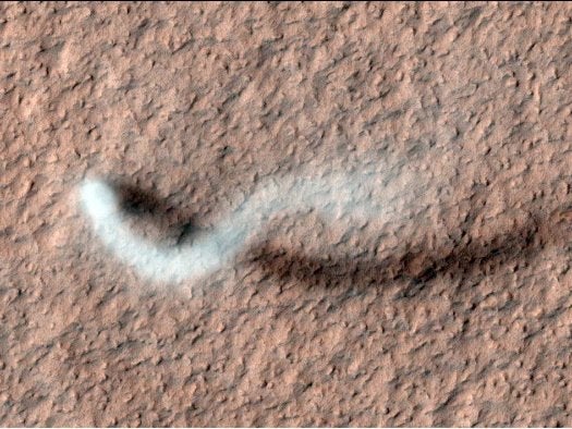 Pictured: a Martian dust devil twisting across the Martian Amazonis Planitia region. The 100-foot-wide column of swirling air was <a href="https://www.popsci.com/technology/article/2012-03/pretty-space-pics-mars-reconnaissance-orbiter-captures-twister-martian-plains/">captured</a> by the Mars Reconnaissance Orbiter last month as it passed over the northern hemisphere of Mars.
