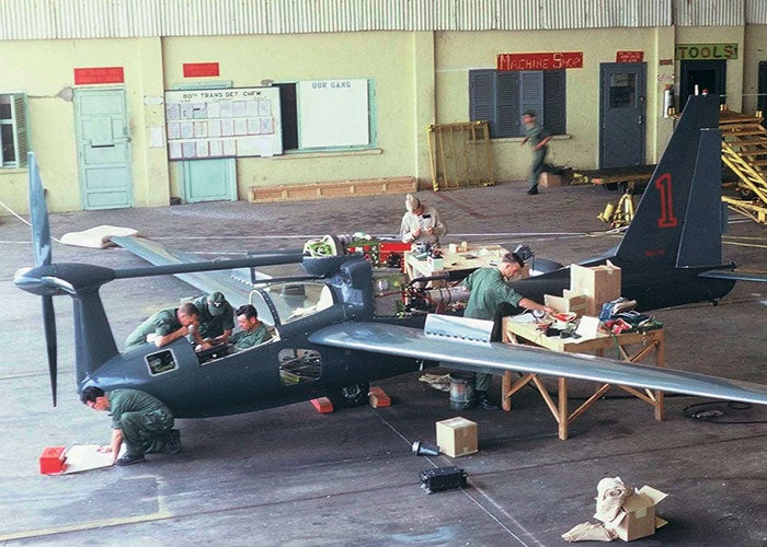 Lockheed and military personnel tweak a QT-2 at an airfield in the Mekong Delta.
