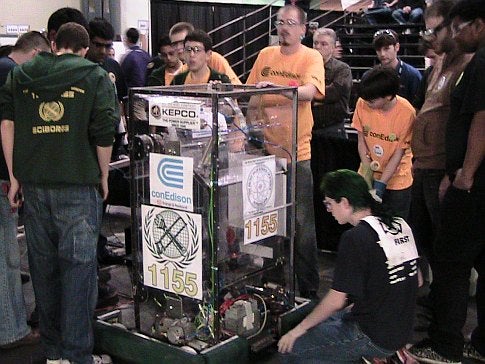 Several people with a homemade robot at the 2009 FIRST Robotics Competition in New York City.