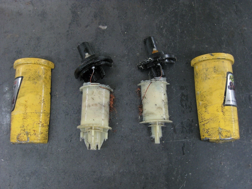 A familiar automotive ignition coil, cut in half. The light colored plastic parts in the center of the picture are the core around which the copper windings were wrapped.