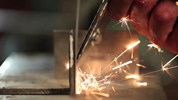 sparks flying from a screwdriver being turned into a chisel