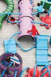 Nine objects—mounds, bumps, walls, waves, noodles—form a playground-in-a-box. Children can spin the bumps, fit the waves together to form a slide, and use the walls (which are semicircular) to build tunnels or, flipped, as seesaws.