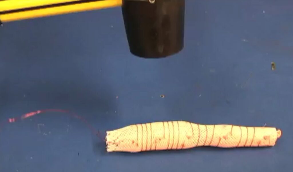 MIT researchers who designed the soft, flexible inchworm-bot tested its mettle by pounding it with this mallet and by stepping on it. The robot survived intact and kept inching away.