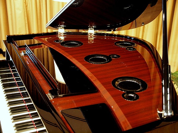 Four sets of speakers reproduce the sounds that would come from the top of a real piano.