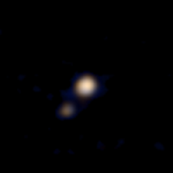 Even though it looks like it was taken on a flip phone, this is actually <a href="http://pluto.jhuapl.edu/Multimedia/Science-Photos/image.php?gallery_id=2&amp;image_id=175">the first-ever color image</a> of everyone's favorite dwarf planet. It was taken by NASA's approaching New Horizons spacecraft from a distance of 71 million miles. The smaller blob is Pluto's largest moon Charon, which is about the size of Texas. This was a preliminary reconstruction by the New Horizons science team. Later NASA released more high-resolution Pluto photos from New Horizons, such as <a href="https://www.popsci.com/more-pluto-mind-controlled-mice-and-other-amazing-images/?image=1">this one</a>.