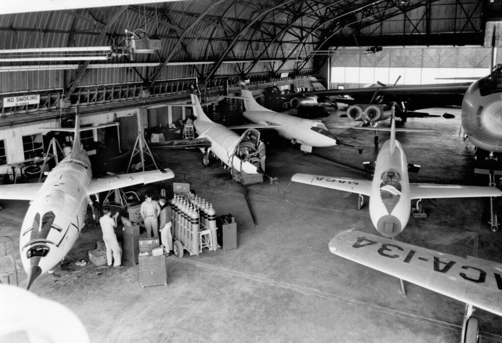 A hanger full of some experimental planes and motherships in 1953. D-558-II (the first plane to fly at Mach 2), D-558-I, B-47, YF-84A, X-4, and F-51.