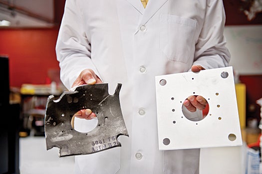 Lab manager Markos Hankin displays aluminum target sample