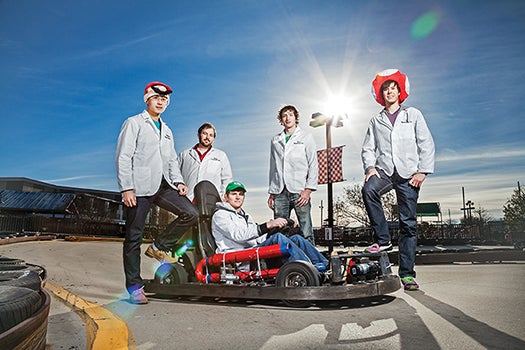 Hunter Smith of Waterloo Labs [second from left] helped four interns transform go-karts into interactive racers fit for a Super Nintendo game.
