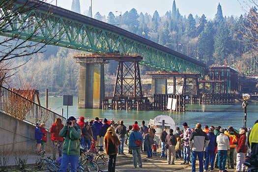 People watch the Sellwood Bridge the 87-year-old southeast Portland span move a few yards to aid the construction of its replacement, Saturday, Jan. 19, 2013 in Portland, Ore. (AP Photo/The Oregonian, Randy L. Rasmussen) MAGS OUT; TV OUT; LOCAL TV OUT; LOCAL INTERNET OUT; THE MERCURY OUT; WILLAMETTE WEEK OUT; PAMPLIN MEDIA GROUP OUT