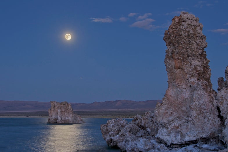 Sunrise at Mono Lake in eastern California, bounded to the west by the Sierra Nevada Mountains. This ancient alkaline lake is known for unusual tufa formations rising from the water's surface, as well as for its hypersalinity and high concentrations of arsenic.