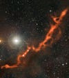 That red streak is a huge string of cosmic dust, trailing off the Taurus molecular cloud about 450 light-years from Earth. There's actually a video of the dust over at <a href="http://www.space.com/14577-space-dust-tentacle-baby-stars-photo.html?utm_source=feedburner&amp;utm_medium=feed&amp;utm_campaign=Feed%3A+spaceheadlines+%28SPACE.com+Headline+Feed%29">Space.com</a>.