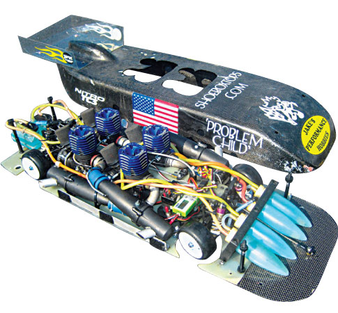 A modified remote control car called Problem Child, with the chassis lifted so you can see its inner components.
