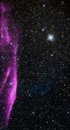 After a massive star in the Milky Way exploded, it produced a shock wave of high-energy particles, seen here in purple. In the background, you can see stars as imaged by the Digital Sky Survey. Chandra captured data on the shock wave in 2003. It is estimated to be 2,400 light-years away.