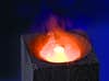 A diamond burning in a pool of liquid oxygen on a block of graphite.