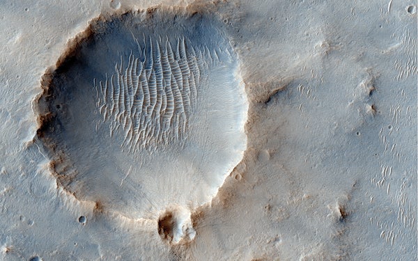 The Compact Reconnaissance Imaging Spectrometer for Mars (CRISM), which studies the mineral composition of Martian terrain, has unearthed clay minerals, or phyllosilicates, within the Miyamoto Crater, shown here. Scientists believe that these minerals may have formed in the presence of water. The Mars Science Laboratory, NASA’s next mission to Mars, might land at this 93-mile-diameter crater to further probe Mars’s composition.