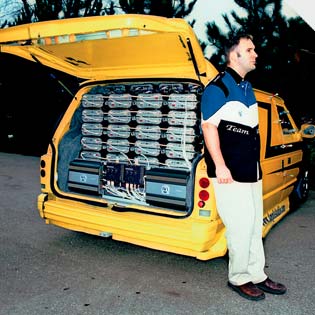 HIS IS WAY, WAY, WAY BIGGER THAN YOURS<br />
Troy Irving and his Dodge Caravan, which has 72 daisy-chained Ample Audio 1500 DX amps