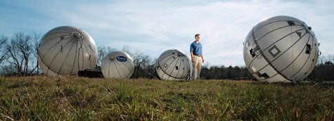 FIELD ARRAY Paul Gierow stands among his inflatable satellite antennas, which can be used alone or in groups for a stronger signal.
