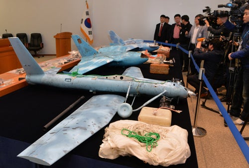 South Korea displays wreckage of three North Korean drones recovered in the last several months. The two drones towards the background (near the South Korean flag) are suspected to be based off of the SKY-09, a civilian Chinese drone.