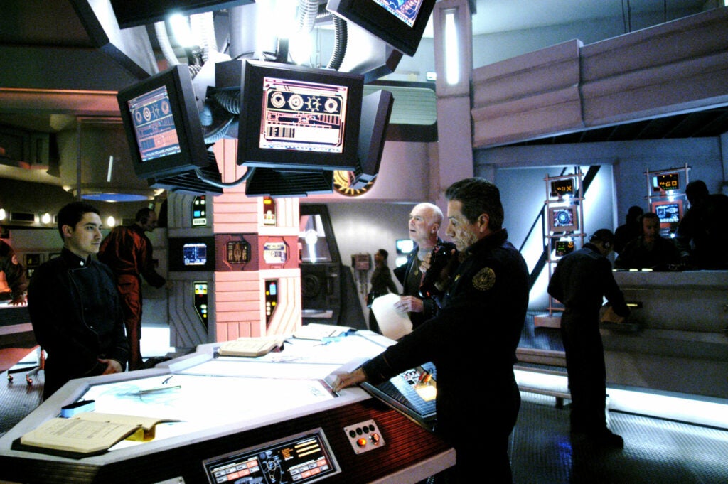 The highly popular television series <em>Battlestar Galactica</em> is the most current manifestation of the space adventure. The soap opera set in space follows humanity's last survivors as they roam around the galaxy fleeing from the relentless "Cylons" who, having turned on their human creators, are now intent on destruction. Like in our previous examples <em>BSG</em> distinguishes between travel at sub-light speeds, and a "hyperlight jump." When they need to get somewhere quickly Commander Adama orders the FTL (faster than light) drive into action. In a hyperlight jump the ship is able to move almost instantaneously from one region of space to another. Applying what we've discussed about general relativity, we might surmise that a "jump" consists of folding space-time and connecting the initially distant regions with an artificially manufactured wormhole. (If only they could harness the incredible amount of energy the FTL would require and use it as a weapon to destroy the Cylons.) What's interesting here is that the crew of <em>BSG</em> isn't confident of exactly where they're going to end up after executing a jump. That makes for good drama. It might be difficult to calculate how to connect up specific distant regions of space-time under pressure. <em>BSG</em> has a science advisor; this doesn't mean physics isn't occasionally discounted for the sake of a cool effect or a convenient convention (for instance: as in most space travel sci-fi we have to assume some unknown method of producing artificial gravity on the ship so that the characters are able to walk around, and yes in <em>BSG</em> there is still sound in space although much more subdued than in the bombastic <em>Star Wars</em> movies), but does make for some interestingly accurate physics moments in the series. Look for them.