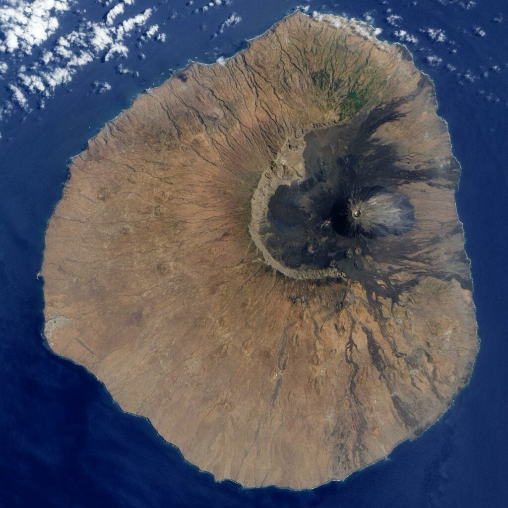 Geologists think that the eastern slope of Fogo volcano crashed into the sea some 65,000 to 124,000 years ago, leaving a giant scar where a new volcano can be seen growing in this satellite image.