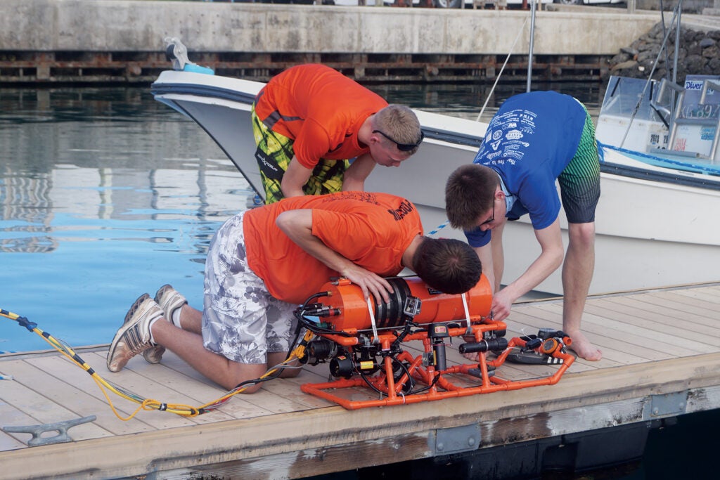 The vessels that typically explore the oceans are professionally engineered. But in Palau, eight students from the Advanced Underwater Robotics team at Michigan's Stockbridge High School also deployed a remotely operated vehicle (ROV). The 40-pound craft successfully dived to 140 feet towing a video-camera system and sonar that it used to image several unknown shipwrecks and a Corsair plane. A local BentProp volunteer had read about the team in 2011 and reached out to the students for assistance. They set to work on building a ROV, using 3-D computer-aided-design software and soldering and electronics skills learned in class. Because Stockbridge, located in a rural community, doesn't have a swimming pool, they tested the craft in a cattle trough. The team also raised $45,000 to pay for the ROV parts and the trip 7,000 miles across the world. "The class is run more like a small business or research team than a traditional classroom," says teacher Robert Richards, a retired Army sergeant. "We're focused on building a robot and doing a mission." The team represents the last level of a robotics program that starts in elementary school. Stockbridge also integrates the Palau project into the curriculum for grades 3 through 12, so 300 kids learn about subjects like island biology and World War II Pacific Theater history. Next year, the students hope to return to Palau for a third field trip—this time, with an autonomous vehicle and hexacopters.