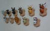 Eleven fake hunting trophies made out of toys, mounted on a white wall.