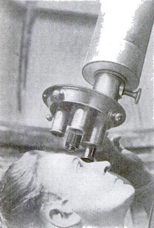 woman looking through a vintage telescope