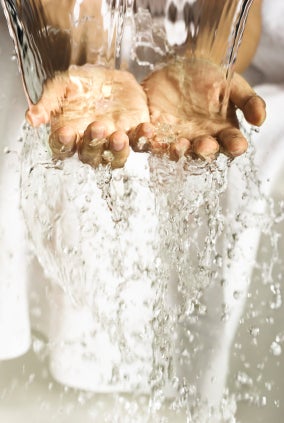 Water cascading over a pair of hands.