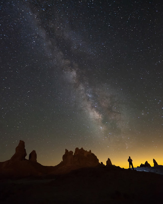 Jefferey Sullivan's self-portrait of his pursuit of the Milky Way swept the People and Space category. And for once, light pollution adds to the scenery with an eerie yellow glow.
