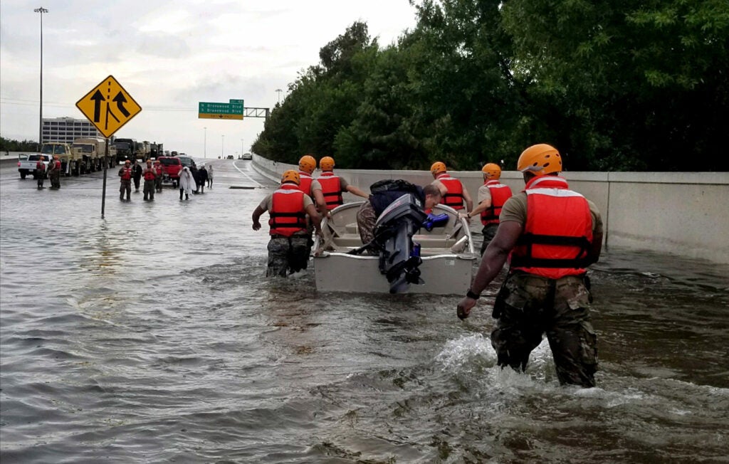 Members of the Texas Army National Guard travel through streets flooded by Hurricane Harvey, Aug. 28, 2017.