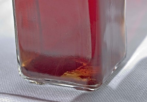 Red maple vinegar in a rectangular glass bottle.