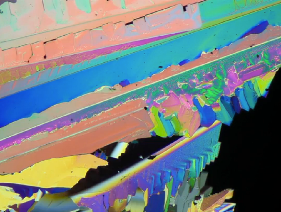 WATCH THE VIDEO!  Elemental sulfur is solid at room temperature. When melted sulfur was placed between two pieces of glass, it solidifies into beautiful multicolored crystals.