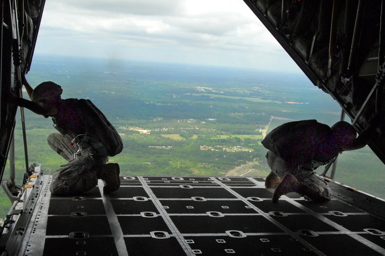 Master Sgt. Dwight Simon and Staff Sgt. Monte Henderson, Jumpmasters assigned to Headquarters, Headquarters Company, U.S. Army Civil Affairs and Psychological Operations Command (Airborne) at Fort Bragg, N.C., watch for the drop zone from the ramp of a C-130 aircraft. Approximately 60 Soldiers participated in the airborne operation on Sicily Drop Zone, D-Day 2009. (U.S. Army Photo by Sgt. Maj. Kelly C. Luster)