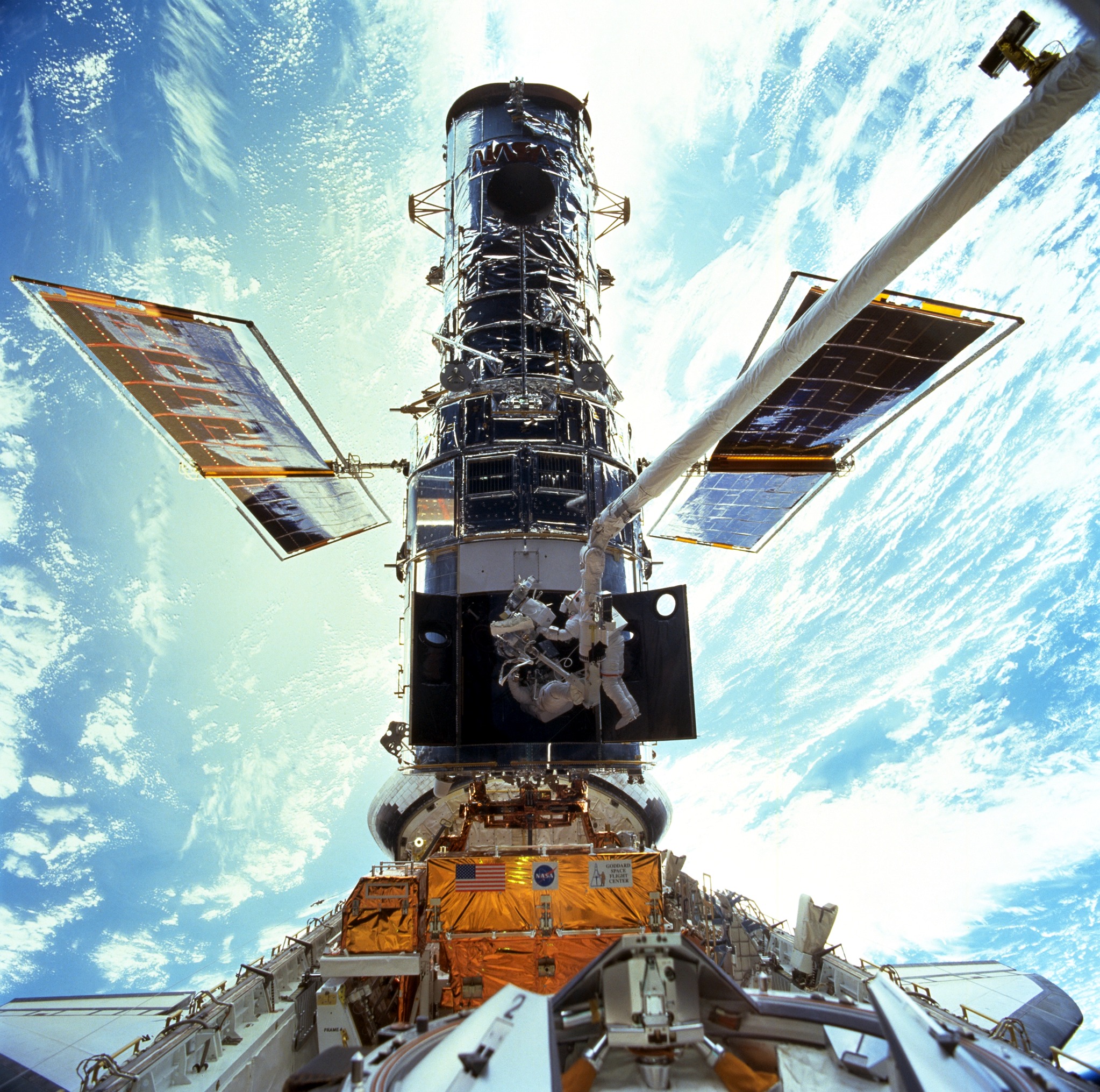 Astronauts Steven L. Smith and John M. Grunsfeld are photographed during the December 1999 Hubble servicing mission of STS-103.