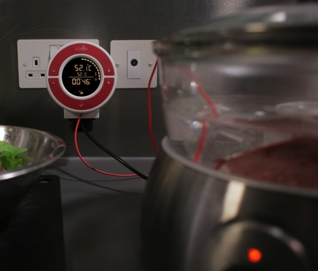 At last, somebody has come up with a friendly, brightly colored plug-and-probe system. <a href="http://www.kickstarter.com/projects/codlo/codlo-a-powerful-compact-controller-for-sous-vide">Codlo</a>, which has achieved its £100,000 goal on Kickstarter but still has a few days left, is a plug-and-probe appliance designed with the home user in mind. Like any self-respecting counter gadget (actually it mounts directly on a wall outlet), it comes in a choice of different colors, but the attention to design includes the interface--which shows a pretty progress bar on a high-contrast LCD screen--and even the inner workings. For the Codlo, engineer Xi-Yen Tan created a new temperature-regulating algorithm called Fluid, which uses the standard <a href="https://en.wikipedia.org/wiki/PID_controller">PID</a> concept but, he says, is "built to make flexible PID capabilities (which cooks need for sous-vide cooking) available for less-technically inclined cooks."