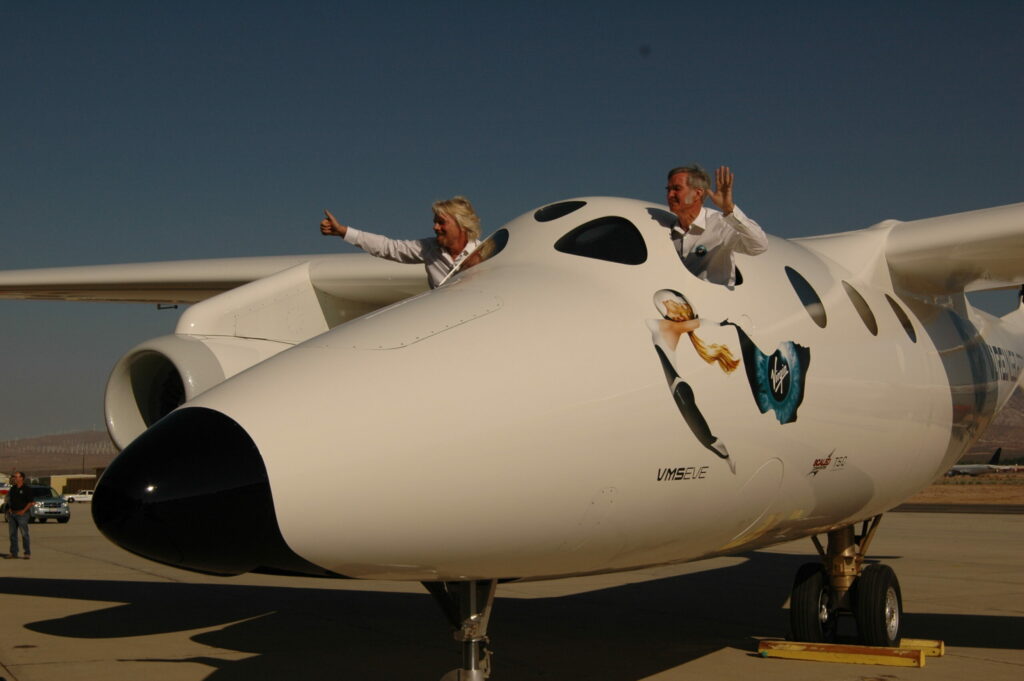 Virgin Galactic owner Richard Branson (left) and air- and spacecraft designer Burt Rutan wave from the cockpit of the White Knight 2.
