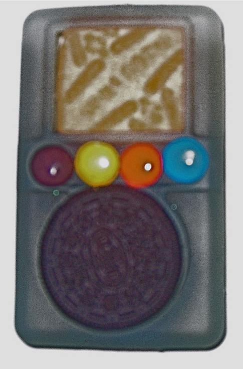 A gel iPod case with an Oreo inside the wheel opening, four M&M candies above it, and a biscuit in the screen opening.