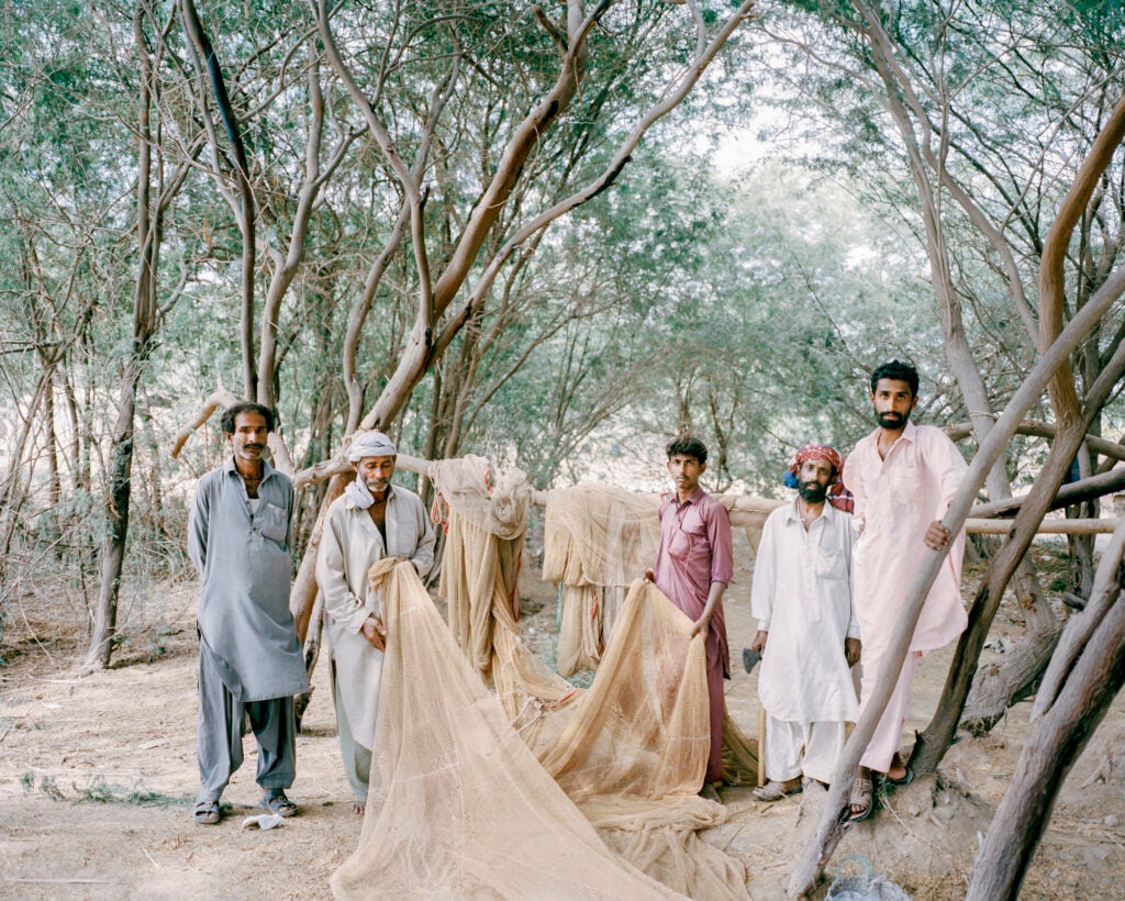 Pakistani fishermen holding a fishing net