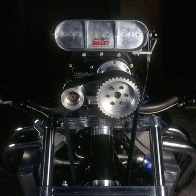 The front of a drag-racing motorcycle with a monster truck engine.